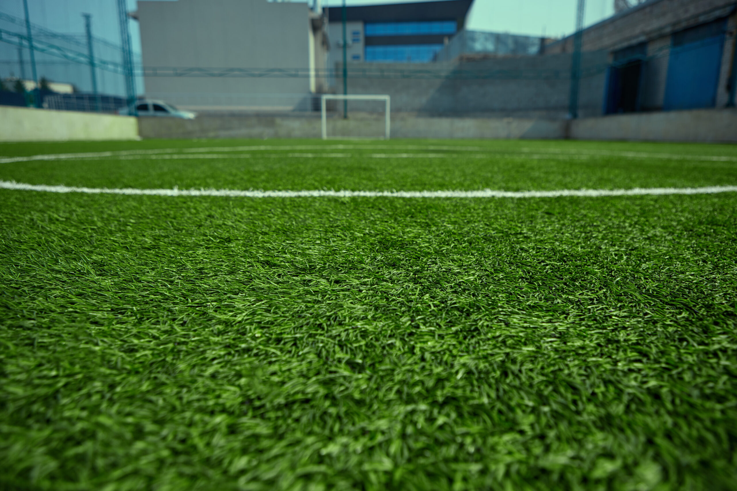empty football field green grass scaled