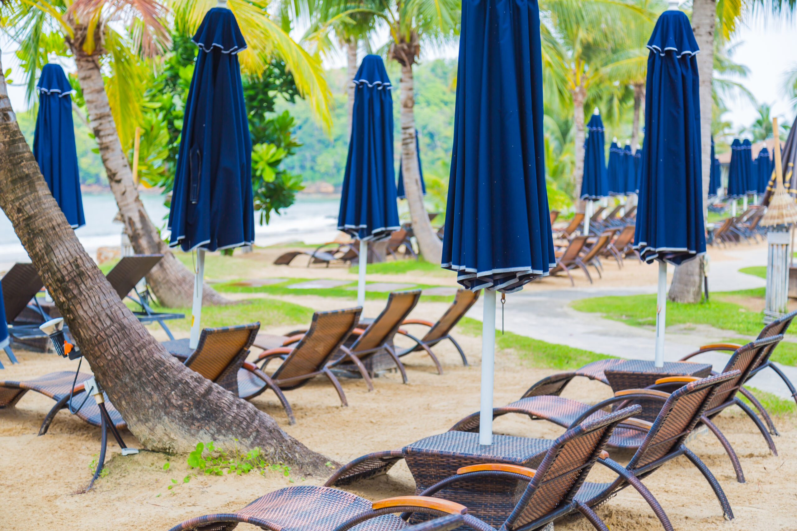 sun loungers with blue parasols scaled
